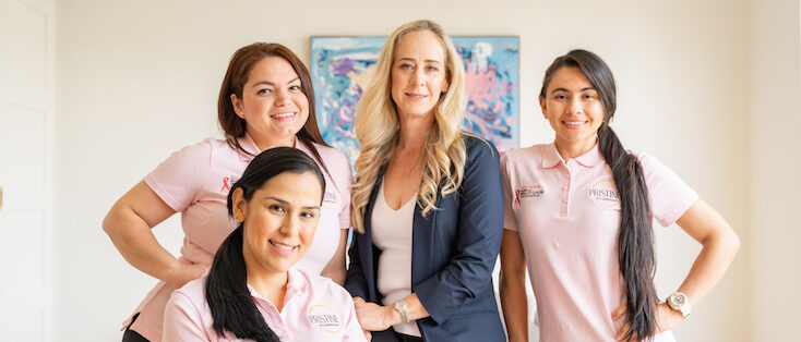 Becky and the team wearing pink shirts for Cleaning for a Cause